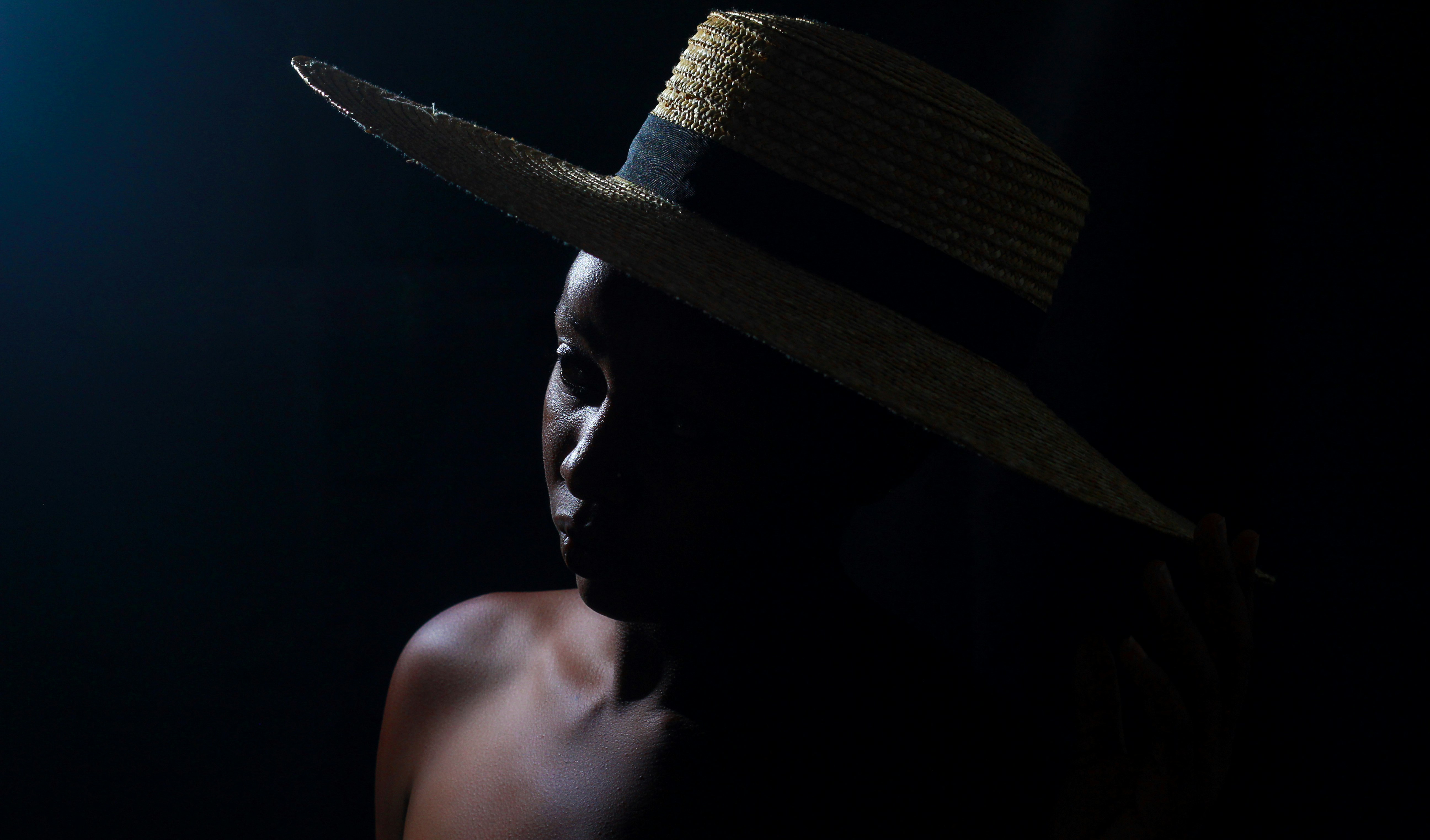 man wearing brown and black fedora hat